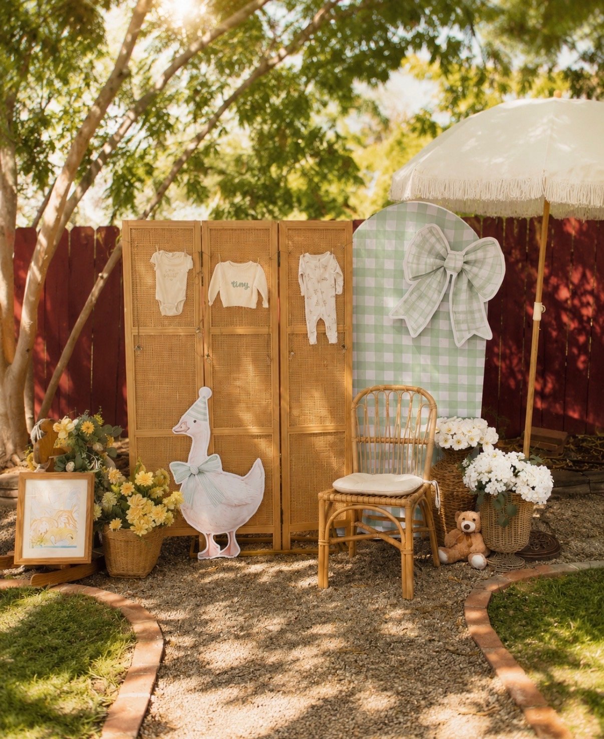 Silly-goose baby shower photo backdrop with cane screen, party-hat goose cutout, and sage gingham arch panel
