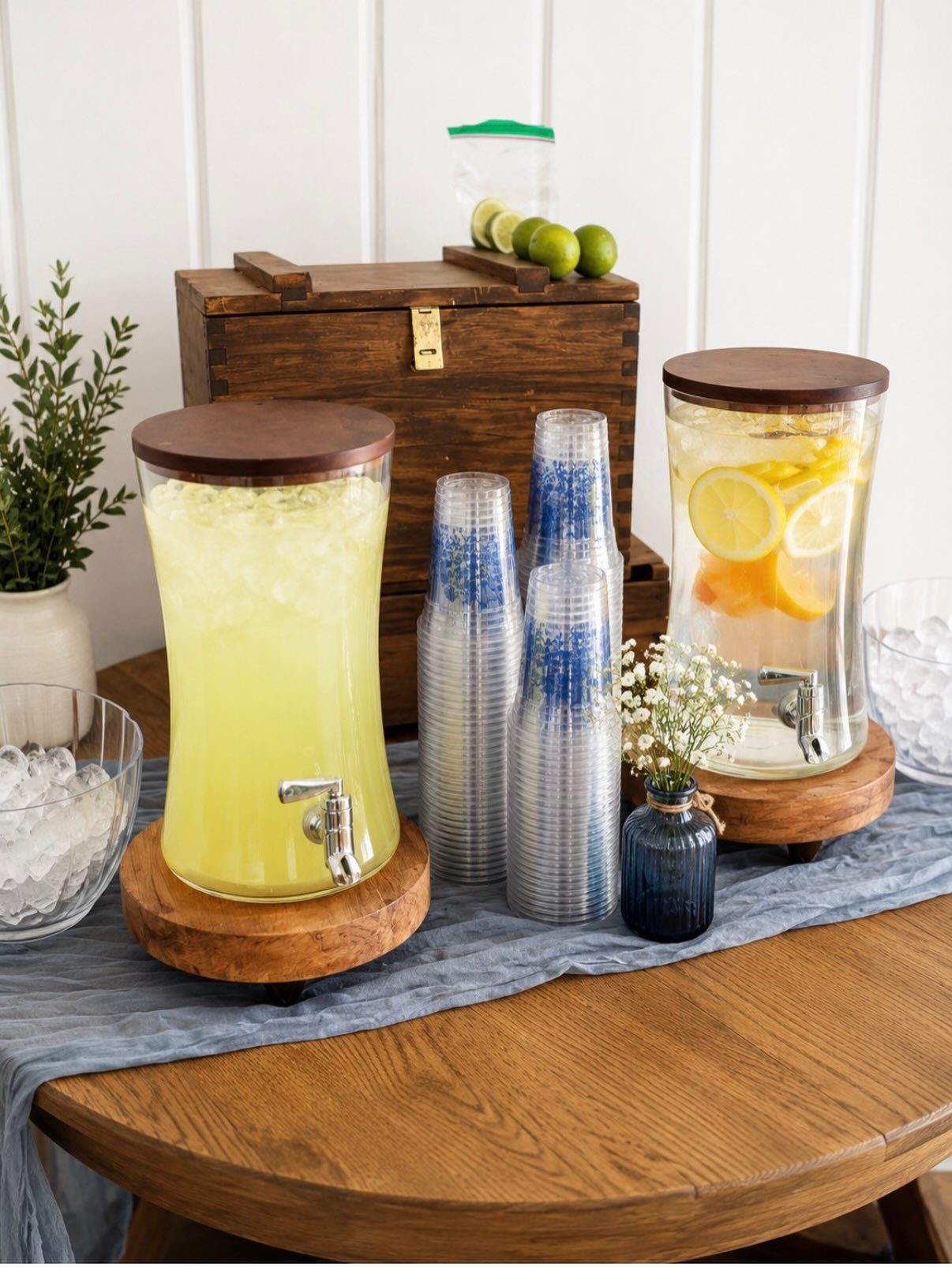 Lemonade and citrus-infused water drink station styled with wood risers and blue cups