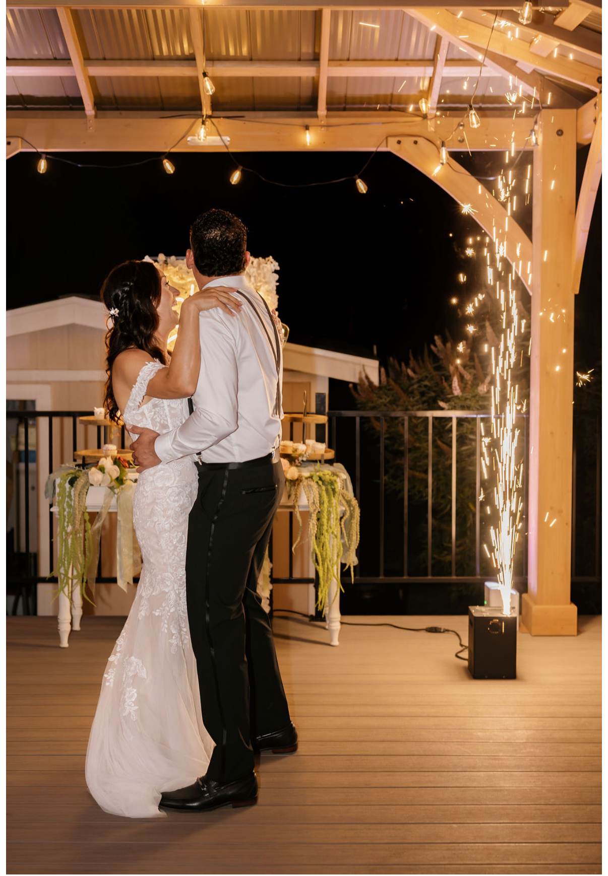Gris and Yami's first dance beneath a cold-spark fountain and string lights